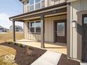 Front entry of new home with covered porch, neutral siding, and a well manicured lawn at 248 Highland Ave, Danville, IN 46122