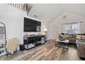 Living room featuring a large TV, comfortable seating, and a dog kennel at 2746 Cadogan Dr, Greenwood, IN 46143