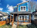 Modern blue home with a unique architectural design and a welcoming front porch at 3271 Winthrop Ave, Indianapolis, IN 46205