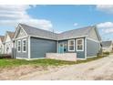 Stylish home with blue siding, gray trim, a charming front yard and a light blue front door at 359 Terrace Ave, Indianapolis, IN 46225