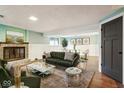 Finished basement featuring a green sofa, fireplace, marble coffee table, and neutral color palette at 3706 Candy Cane Dr, Indianapolis, IN 46227