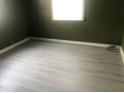 Simple bedroom with light gray vinyl flooring and olive green walls at 4502 Evanston Ave, Indianapolis, IN 46205