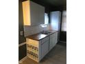 Updated kitchen with white cabinets, butcher block countertops, and subway tile backsplash at 4502 Evanston Ave, Indianapolis, IN 46205