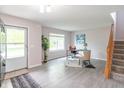 Bright entryway featuring wood floors, staircase, modern decor and a view of the front yard at 14446 Chapelwood Ln, Fishers, IN 46037