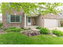 Inviting entrance to a brick home with a covered porch, landscaped garden, and two car garage at 14446 Chapelwood Ln, Fishers, IN 46037