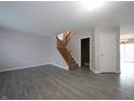 Bright living room with wood flooring, a staircase, and neutral paint throughout at 14446 Chapelwood Ln, Fishers, IN 46037
