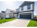 Charming two-story home with a well-maintained lawn and long driveway leading to an attached two-car garage at 1579 Hanover St, Danville, IN 46122