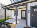 Welcoming front porch with dark pillars and trim, leading to the front door and attached garage at 1579 Hanover St, Danville, IN 46122