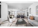Open-concept living space with modern furnishings, seamlessly connecting to a stylish kitchen at 17366 Newton Main St, Westfield, IN 46074