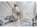 Bright foyer with a staircase, marble floors, and a decorative front door at 2227 Hidden Orchard Ct, Indianapolis, IN 46228