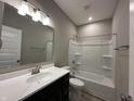 Modern bathroom features a shower-tub combo, a large mirror and a dark vanity at 1023 Cyprian Way, Lebanon, IN 46052