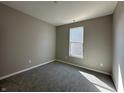 Comfortable carpeted bedroom featuring a large window, neutral walls, and plenty of light at 1023 Cyprian Way, Lebanon, IN 46052
