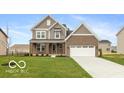 Charming two-story home with a well-manicured lawn, brick and siding exterior and an attached two-car garage at 15468 Streamwood Dr, Fishers, IN 46037