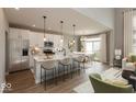 Bright, open kitchen with a large center island, stainless steel appliances, and a view into the dining area at 15468 Streamwood Dr, Fishers, IN 46037
