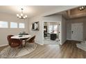 Charming dining area with modern table and chairs, seamlessly connecting to a bright and functional home office space at 1019 Cyprian Way, Lebanon, IN 46052