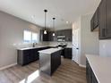 Modern kitchen with gray cabinets, stainless steel appliances, a kitchen island and lots of counter space at 1019 Cyprian Way, Lebanon, IN 46052