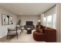 Bright living room showcases comfortable seating, contemporary artwork, and a minimalist entertainment center at 1019 Cyprian Way, Lebanon, IN 46052
