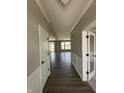 Long view down a hallway with hard surface floors into a spacious living area at 12023 Crestwater Ct, Fishers, IN 46037