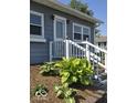 Close up of front entrance with meticulously kept landscaping at 1517 N E St, Elwood, IN 46036