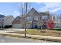 Inviting two-story home with brick accents, an attached two-car garage, and mature landscaping at 12997 Bartlett Dr, Fishers, IN 46037