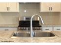 Modern kitchen features stainless steel appliances, white cabinets, and a granite countertop at 1684 Linden Ln, Greenfield, IN 46140