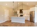 Modern kitchen with white cabinets, stainless steel appliances, and a large island at 1732 Linden Ln, Greenfield, IN 46140