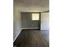 Inviting room featuring hardwood floors, neutral paint, and a bright window with a door, offering a comfortable atmosphere at 2270 Wheeler St, Indianapolis, IN 46218