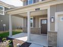 Welcoming front porch with sturdy columns and a stylish front door with glass accents at 1567 Hanover St, Danville, IN 46122