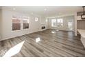 Spacious living room with modern flooring and ample natural light from large windows at 3917 Holly Brook Dr, Westfield, IN 46062