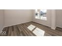 Sunlit living room showcasing hardwood floors and neutral walls at 4958 Reavie Ct, Noblesville, IN 46062