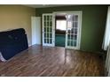 Living room featuring hardwood floors and glass French doors into the next room at 406 S Fenton Ave, Indianapolis, IN 46219
