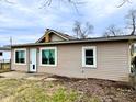 Attractive single-story house with a white front door, large windows, and easy-to-maintain landscaping at 64 S 10Th Ave, Beech Grove, IN 46107