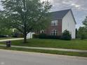 View of the home's front yard with lush green grass and mature shade trees at 13271 Lorenzo Blvd, Carmel, IN 46074