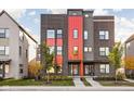 Contemporary three-story home with contrasting brick and red metal siding at 1825 N New Jersey St, Indianapolis, IN 46202