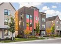 Modern three-story home with brick and metal siding, showcasing a stylish design at 1825 N New Jersey St, Indianapolis, IN 46202