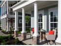 Front porch with white columns, seating, and a small table at 537 Gilder Dr, Carmel, IN 46032