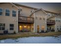 Townhome backyard with deck, patio furniture, and some winter snow at 9725 Thorne Cliff Way # 101, Fishers, IN 46037