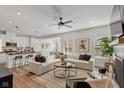 Open concept living room with sectional sofa, fireplace, and hardwood floors at 9725 Thorne Cliff Way # 101, Fishers, IN 46037