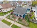 Charming blue home with brick-accented porch, fenced yard, and a cozy, inviting atmosphere at 323 E Franklin St, Shelbyville, IN 46176