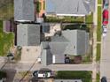 Aerial view of the house and detached garages show roof and back yard details at 323 E Franklin St, Shelbyville, IN 46176