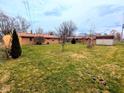 Spacious backyard featuring a well-maintained lawn and mature trees, perfect for outdoor activities at 4619 Mac Dr, Anderson, IN 46013