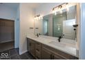 Modern bathroom featuring a double vanity, large mirror, and glass shower with sleek fixtures at 4991 Elaine Ct, Noblesville, IN 46062