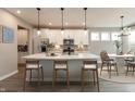 Bright, modern kitchen features white cabinetry, stainless steel appliances, and a large island with seating at 6973 Oakdale Ln, Avon, IN 46123