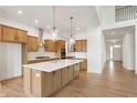 Modern kitchen featuring an island, stainless steel appliances, wooden cabinets, and pendant lighting at 770 Leila Mae Ln, Westfield, IN 46074