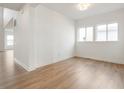 Bright, airy living room with wood floors, white walls, two windows and high ceilings providing abundant natural light at 770 Leila Mae Ln, Westfield, IN 46074