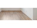 Close-up on new wood flooring and clean white baseboards, showcasing the quality finishes in the home at 770 Leila Mae Ln, Westfield, IN 46074