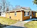 Single-story brick house with a spacious two-car garage and convenient side entrance at 2245 Wallace Ave, Columbus, IN 47201