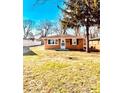Cozy single-story brick home with a well-manicured lawn under a clear blue sky at 2245 Wallace Ave, Columbus, IN 47201