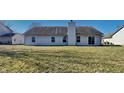 Large backyard features a chimney, large windows, and a sliding door to the patio at 6110 Prairie Stream Way, Columbus, IN 47203
