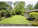 Spacious backyard featuring well-maintained grass, mature trees, and privacy at 6348 Kingsley Dr, Indianapolis, IN 46220